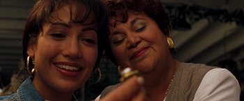 Movie still from “Selena” (1997), directed by Gregory Nava – Two women are looking at a gold ring; Close Up shot, High angle