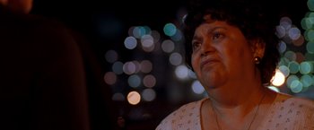 Movie still from “Selena” (1997), directed by Gregory Nava – A woman's face in front of a blurry background; Close Up shot, Low angle