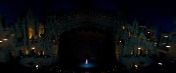 Movie still from “Selena” (1997), directed by Gregory Nava – A woman standing on a stage in front of an audience; Extreme Wide shot, High angle