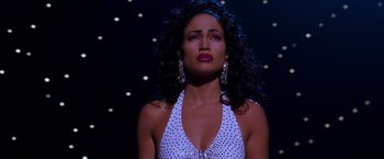 Movie still from “Selena” (1997), directed by Gregory Nava – A woman in a polka dot dress with her eyes closed; Close Up shot, Low angle