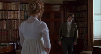 Movie still from “Sense and Sensibility” (1995), directed by Ang Lee – A man and a woman standing in front of each other in a library; Medium shot, Over the shoulder angle