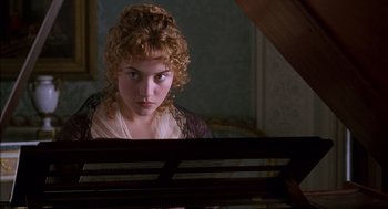 Movie still from “Sense and Sensibility” (1995), directed by Ang Lee – A young woman looking at the camera from a piano; Close Up shot, Over the shoulder angle