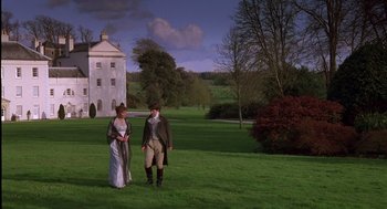 Movie still from “Sense and Sensibility” (1995), directed by Ang Lee – A man and a woman standing on a lush green field; Wide shot, Low angle