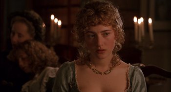 Movie still from “Sense and Sensibility” (1995), directed by Ang Lee – A beautiful young woman with curly blonde hair wearing a green dress; Close Up shot, Over the shoulder angle