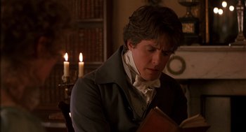 Movie still from “Sense and Sensibility” (1995), directed by Ang Lee – A man reading a book in front of candles in a room; Close Up shot, Over the shoulder angle