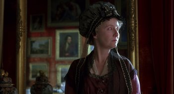 Movie still from “Sense and Sensibility” (1995), directed by Ang Lee – A woman wearing a hat in a room with paintings on the walls; Close Up shot, Low angle