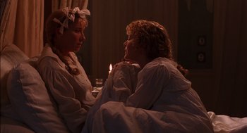 Movie still from “Sense and Sensibility” (1995), directed by Ang Lee – Two women sitting next to each other on a bed; Close Up shot, Over the shoulder angle