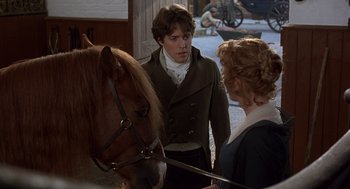 Movie still from “Sense and Sensibility” (1995), directed by Ang Lee – A man and a woman standing in front of a horse; Medium shot, Over the shoulder angle