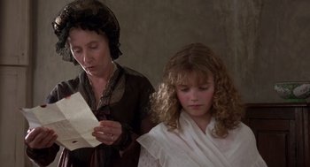 Movie still from “Sense and Sensibility” (1995), directed by Ang Lee – An older woman and a young girl looking at a piece of paper; Close Up shot, High angle