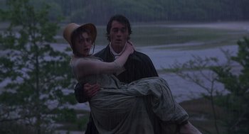 Movie still from “Sense and Sensibility” (1995), directed by Ang Lee – A man and a woman are holding each other in the rain; Medium shot, High angle