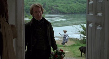 Movie still from “Sense and Sensibility” (1995), directed by Ang Lee – A man and a woman walking down a path near a body of water; Medium shot, Over the shoulder angle