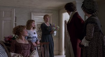 Movie still from “Sense and Sensibility” (1995), directed by Ang Lee – A group of people standing in a living room; Medium shot, Over the shoulder angle