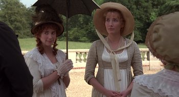 Movie still from “Sense and Sensibility” (1995), directed by Ang Lee – Two women dressed in period clothing standing next to each other holding an umbrella; Medium shot, High angle