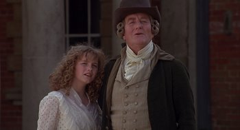 Movie still from “Sense and Sensibility” (1995), directed by Ang Lee – A man and a woman standing next to each other; Medium shot, Low angle
