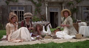 Movie still from “Sense and Sensibility” (1995), directed by Ang Lee – A group of women sitting on the ground in front of a house; Wide shot, High angle