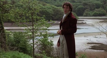 Movie still from “Sense and Sensibility” (1995), directed by Ang Lee – A man standing in front of a body of water; Medium shot, Over the shoulder angle