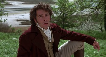 Movie still from “Sense and Sensibility” (1995), directed by Ang Lee – A man in a red jacket sitting on a bench; Medium shot, High angle