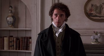 Movie still from “Sense and Sensibility” (1995), directed by Ang Lee – A man in a black coat standing in a room; Medium shot, Over the shoulder angle