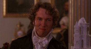 Movie still from “Sense and Sensibility” (1995), directed by Ang Lee – A person with curly hair wearing a suit; Close Up shot, Over the shoulder angle