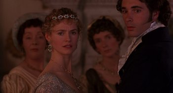 Movie still from “Sense and Sensibility” (1995), directed by Ang Lee – A group of people standing next to each other in a room; Close Up shot, Over the shoulder angle
