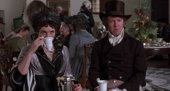 Movie still from “Sense and Sensibility” (1995), directed by Ang Lee – A man and a woman sitting at a table drinking tea; Medium shot, High angle