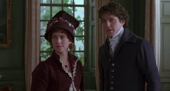 Movie still from “Sense and Sensibility” (1995), directed by Ang Lee – A man and a woman standing next to each other; Close Up shot, Over the shoulder angle