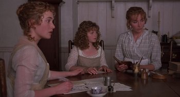 Movie still from “Sense and Sensibility” (1995), directed by Ang Lee – A group of people sitting at a table with papers; Medium shot, High angle