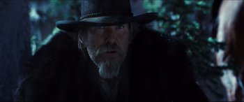 Movie still from “Seraphim Falls” (2006), directed by David Von Ancken – A man with a beard wearing a black hat; Close Up shot, Low angle