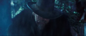 Movie still from “Seraphim Falls” (2006), directed by David Von Ancken – A man with a long beard wearing a black hat; Close Up shot, Low angle