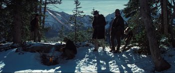 Movie still from “Seraphim Falls” (2006), directed by David Von Ancken – A group of men standing on top of a snow covered slope; Wide shot, Low angle