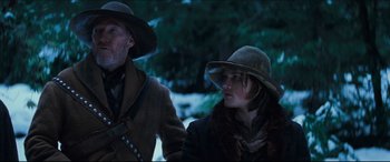 Movie still from “Seraphim Falls” (2006), directed by David Von Ancken – A man and a woman wearing hats in the snow; Medium shot, Low angle