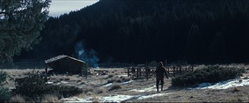 Movie still from “Seraphim Falls” (2006), directed by David Von Ancken – A man walking across a snow covered field; Extreme Wide shot, Low angle
