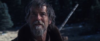 Movie still from “Seraphim Falls” (2006), directed by David Von Ancken – An older man with a beard and a fur coat; Close Up shot, Over the shoulder angle