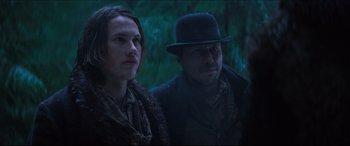 Movie still from “Seraphim Falls” (2006), directed by David Von Ancken – A man and a woman standing next to each other in a forest; Medium shot, Low angle