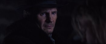 Movie still from “Seraphim Falls” (2006), directed by David Von Ancken – A person wearing a hat and looking at the camera; Close Up shot, Over the shoulder angle