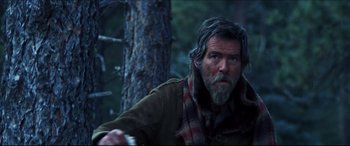 Movie still from “Seraphim Falls” (2006), directed by David Von Ancken – A man with a beard and a scarf in the woods; Close Up shot, Over the shoulder angle