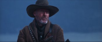 Movie still from “Seraphim Falls” (2006), directed by David Von Ancken – An older man wearing a cowboy hat and a brown coat; Close Up shot, Low angle