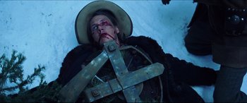 Movie still from “Seraphim Falls” (2006), directed by David Von Ancken – A man in a cowboy hat is laying in the snow; Close Up shot, Low angle