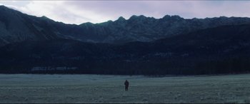 Movie still from “Seraphim Falls” (2006), directed by David Von Ancken – A person standing in a field with mountains in the background; Extreme Wide shot, Low angle