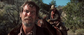 Movie still from “Seraphim Falls” (2006), directed by David Von Ancken – Two men on horses in a field with trees in the background; Close Up shot, Low angle