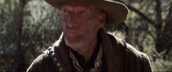 Movie still from “Seraphim Falls” (2006), directed by David Von Ancken – An old man with a beard wearing a cowboy hat; Close Up shot, Low angle