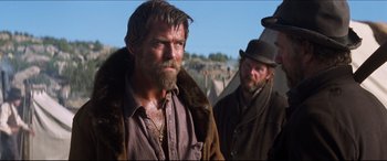 Movie still from “Seraphim Falls” (2006), directed by David Von Ancken – A man with a long beard and a man with a hat; Medium shot, Over the shoulder angle