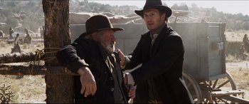 Movie still from “Seraphim Falls” (2006), directed by David Von Ancken – A man in a cowboy hat and a man in a cowboy hat; Medium shot, Over the shoulder angle