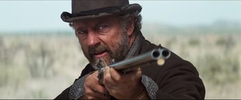 Movie still from “Seraphim Falls” (2006), directed by David Von Ancken – A person holding a gun; Close Up shot, Low angle