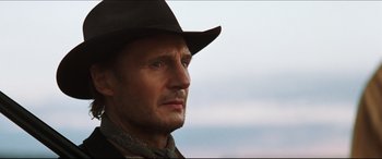 Movie still from “Seraphim Falls” (2006), directed by David Von Ancken – A person wearing a cowboy hat; Close Up shot, Low angle