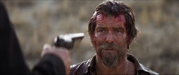 Movie still from “Seraphim Falls” (2006), directed by David Von Ancken – A person holding a gun; Close Up shot, Over the shoulder angle