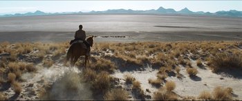 Movie still from “Seraphim Falls” (2006), directed by David Von Ancken – A man riding a horse through the desert; Extreme Wide shot, High angle