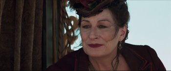 Movie still from “Seraphim Falls” (2006), directed by David Von Ancken – An older woman wearing a hat and a necklace; Close Up shot, Over the shoulder angle