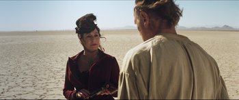 Movie still from “Seraphim Falls” (2006), directed by David Von Ancken – A man and a woman standing next to each other in the desert; Medium shot, Over the shoulder angle