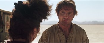 Movie still from “Seraphim Falls” (2006), directed by David Von Ancken – A man in a brown shirt looking at another man in a brown shirt; Close Up shot, Over the shoulder angle
